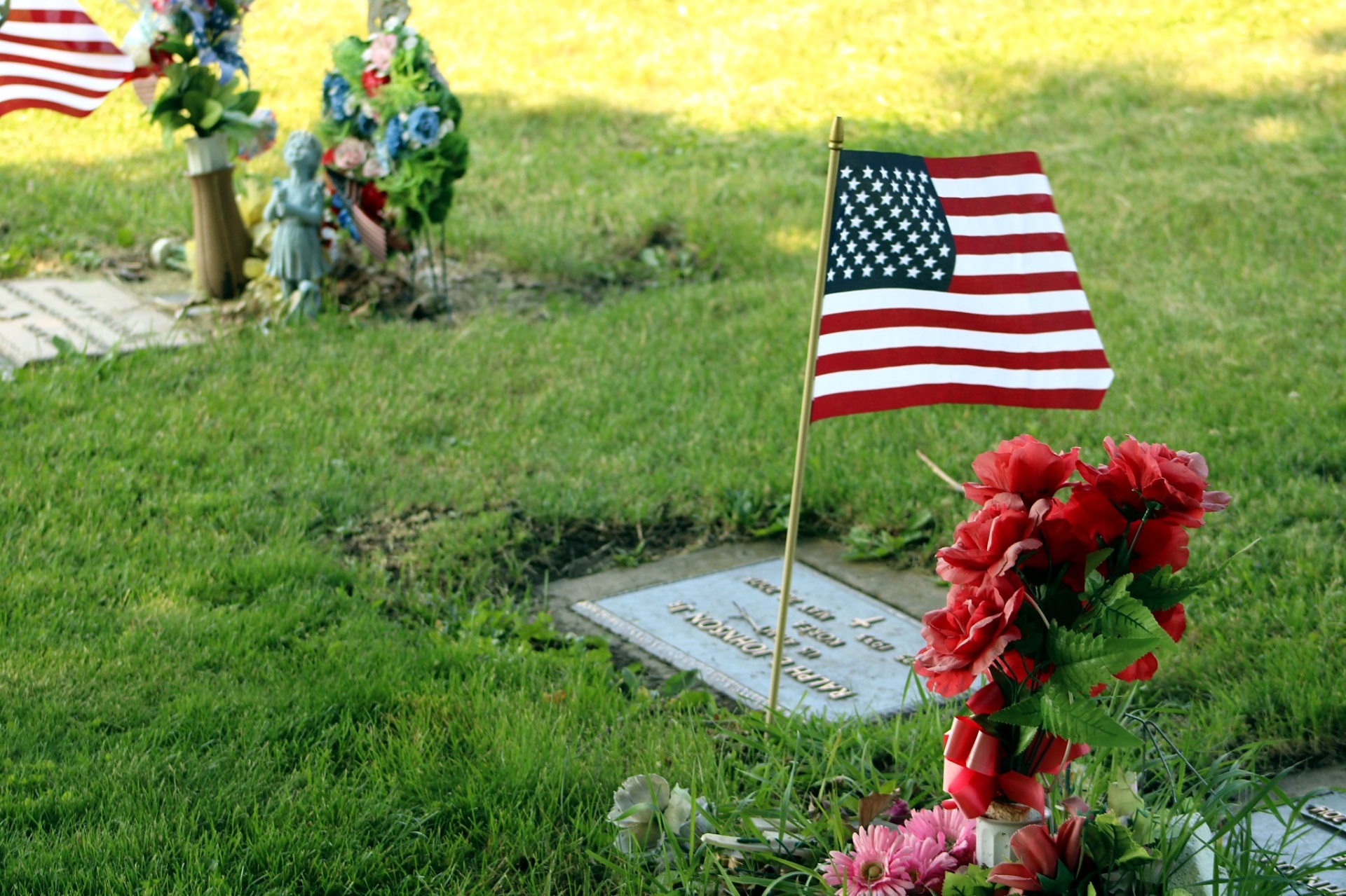 Flag and roses placed at the Johnson family marker