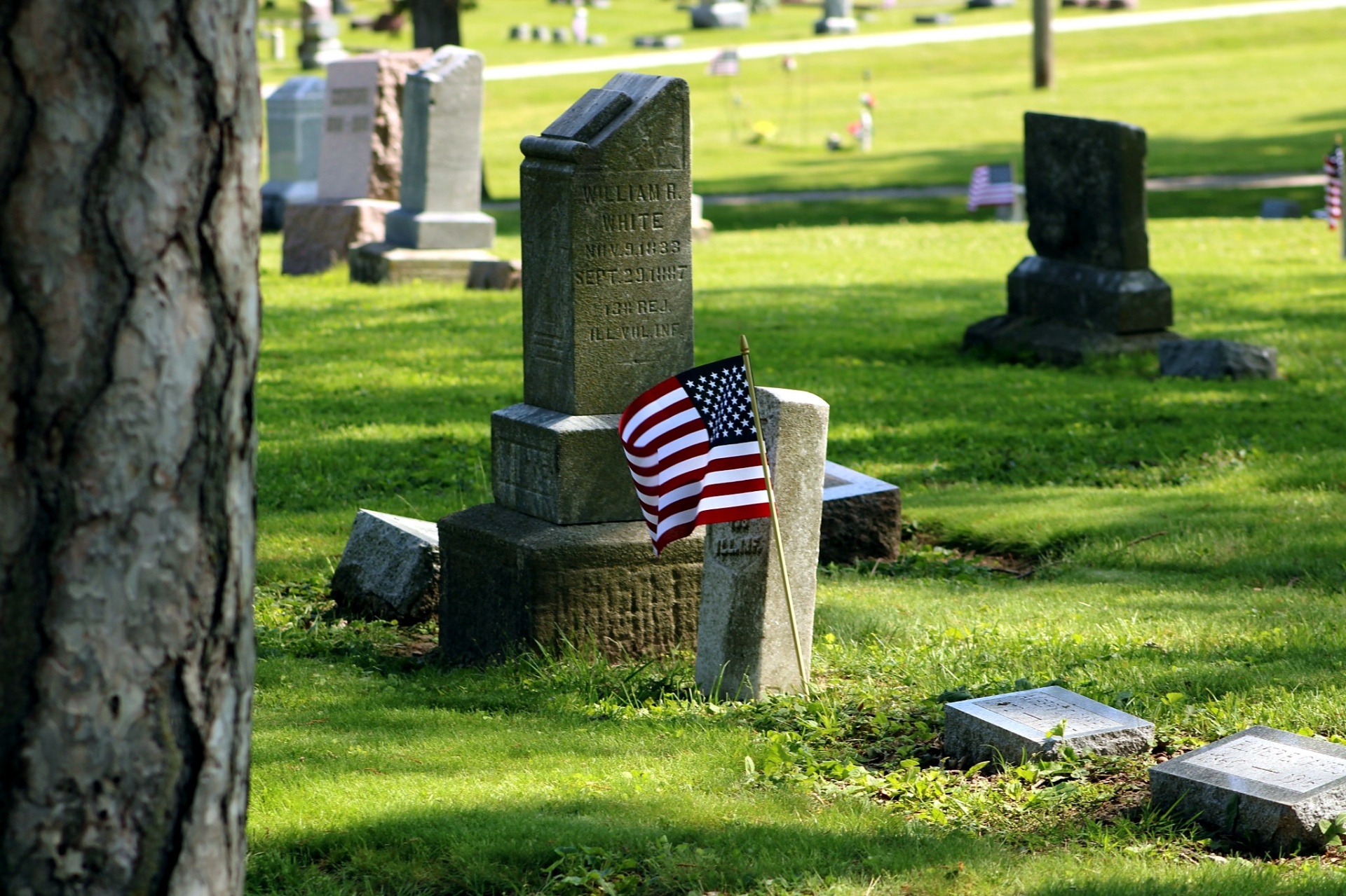 Flag placed beside the marker of William R. White, 13th Illinois Volunteer Infantry